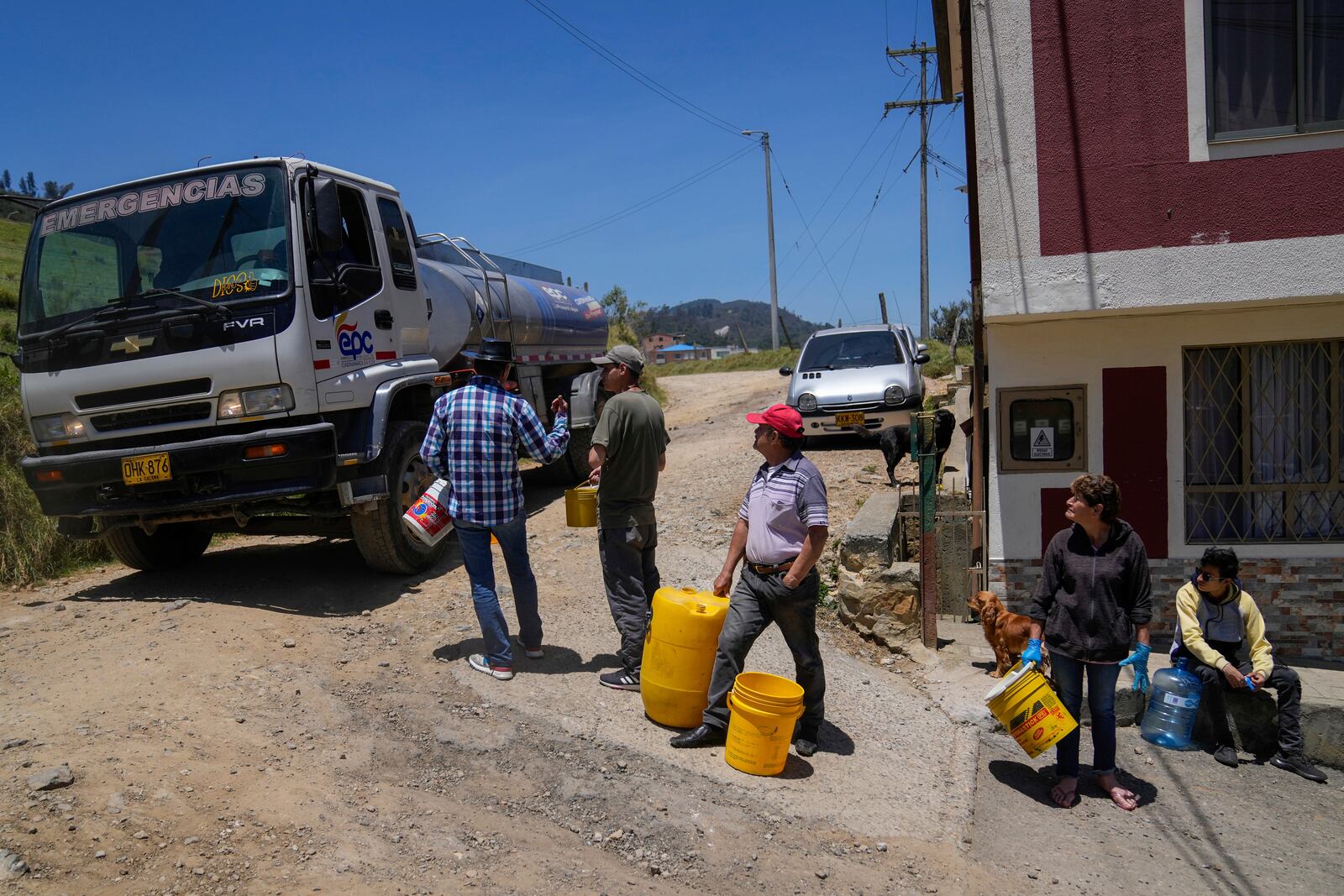FILE - Residents collect water from a truck amid water rationing in La Calera, on the outskirts of Bogota, Colombia, April 16, 2024. (AP Photo/Fernando Vergara, File)