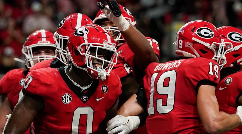 Georgia tight end Darnell Washington (0) celebrates after scoring a touchdown in the first half of the Southeastern Conference championship NCAA college football game, Saturday, Dec. 3, 2022, in Atlanta. (AP Photo/Brynn Anderson)