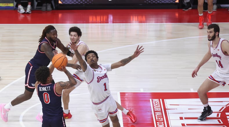 Dayton's Javon Bennett makes a 3-pointer and draws a foul in the final seconds of the first half against Bradley in the first round of the National Invitation Championship on Wednesday, March 18, 2026, at Carver Arena in Peoria, Ill. David Jablonski/Staff