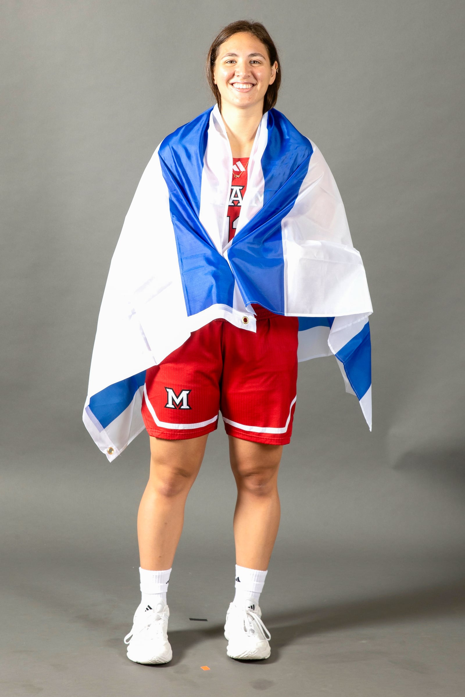 Miami point guard Tamar Singer with the Israeli flag: “I’m proud to represent my country.” CONTRIBUTED PHOTO