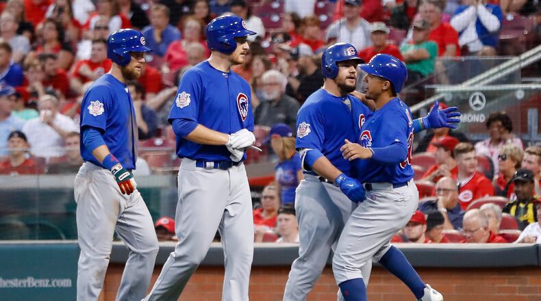 Chicago Cubs’ Kyle Schwarber, center right, celebrates with Jon Jay, right, Mike Montgomery, center left, and Ben Zobrist after hitting a three-run home run off Cincinnati Reds starting pitcher Asher Wojciechowski during the fourth inning of a baseball game, Wednesday, Aug. 23, 2017, in Cincinnati. (AP Photo/John Minchillo)