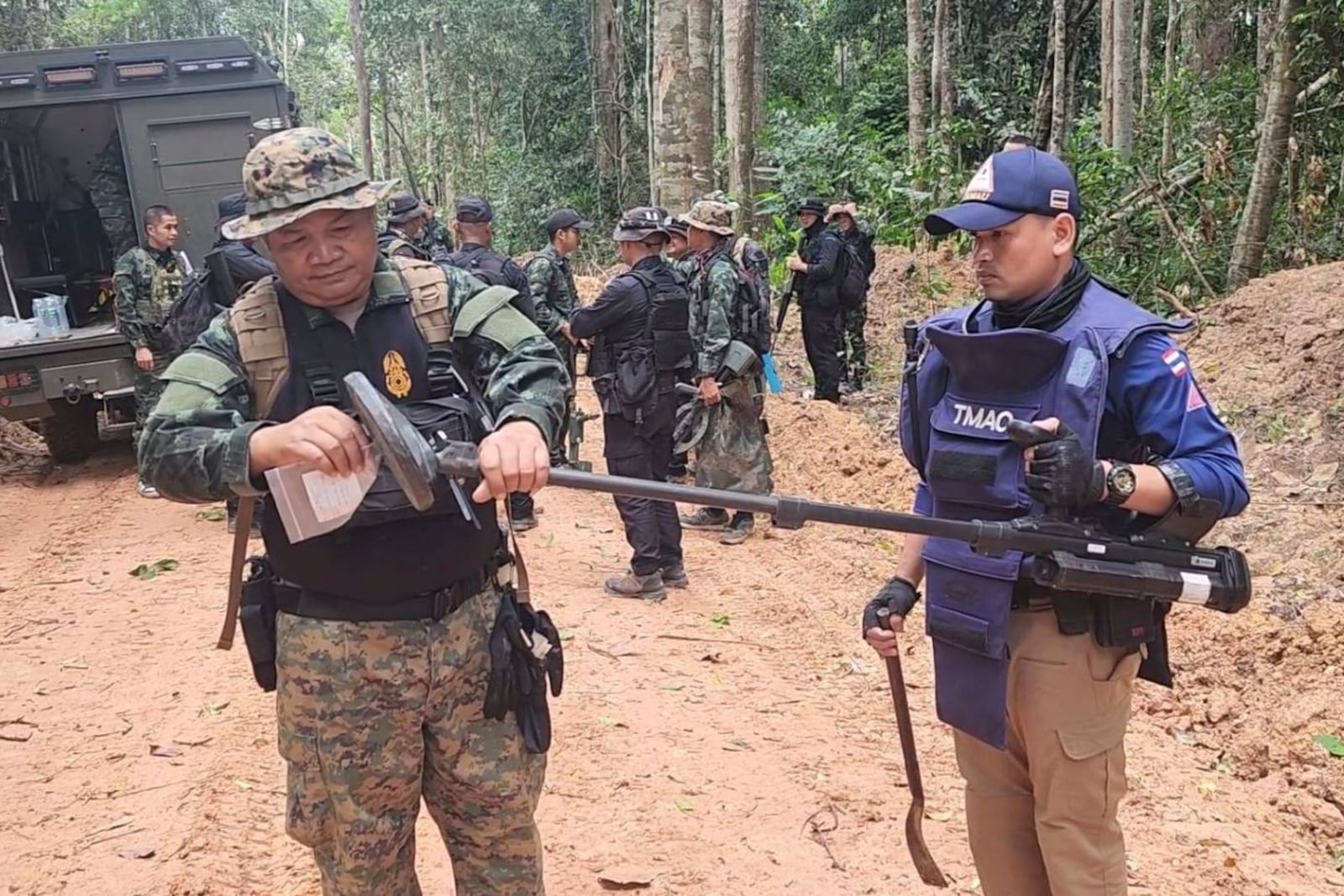 In this Sunday, July, 2025, photo released by the Royal Thai Army, Thai soldiers inspect a border area in Ubon Ratchathani†province where the Royal Thai Army said two anti-personnel landmines were found. (Royal Thai Army via AP)