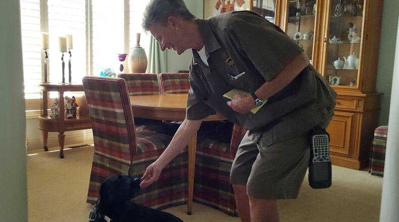 Teddy and his friend, UPS driver Diane “Peanut” Burns. KARIN SPICER/CONTRIBUTED