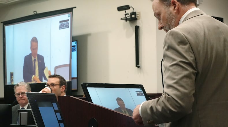 Assistant Ohio Attorney General Matthew Meyer cross examines Sen. Jon Husted, R-Ohio during testimony testifies Zoom during the trial of ex-FirstEnergy Senior Vice President Michael Dowling and former FirstEnergy CEO Chuck Jones in Summit County Common Pleas Judge Susan Baker Ross's courtroom on Wednesday, March 11, 2026 in Akron, Ohio. (Mike Cardew /Akron Beacon Journal via AP, Pool)
