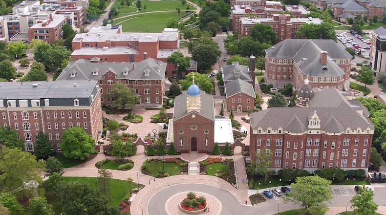 The iconic dome and cross on the Chapel of the Immaculate Conception is the centerpiece of UDs campus. The top of the cross is 95 feet above the ground. The cross is 7 feet, 4 inches tall from the ball to the top of the cross. The arms of the cross extend 4 feet, 6 inches. The Chapel is flanked by St. Mary's Hall, left, and St. Joseph Hall, right.   TY GREENLEES / STAFF