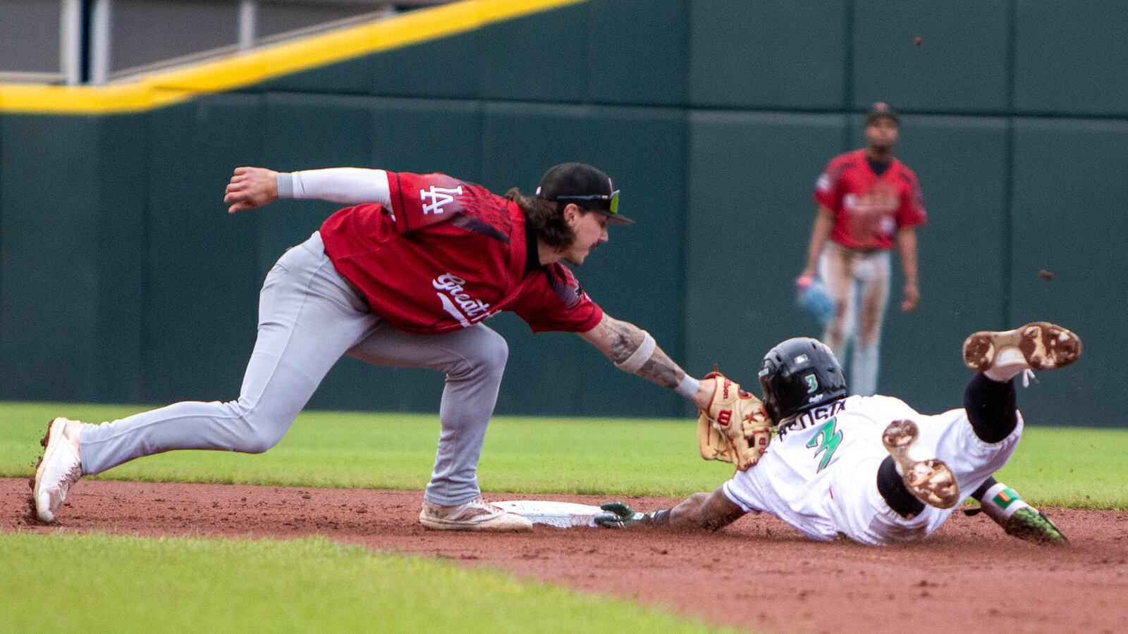 Dayton's Victor Acosta steals second base in the first inning ahead of the tag by Great Lakes shortstop Jordan Thompson. Jeff Gilbert/CONTRIBUTED