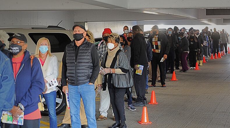 Long lines greeted voters at the Montgomery County Board of Elections on Tuesday, Oct. 6, 2020, as early voting began for the November general election. Early in-person voting in the state lasts until Nov. 2 and absentee ballots can be dropped off at the board office until Election Day, which is Nov. 3. In Montgomery County, registered voters can cast their ballot at the board of elections located at 451 W. Third St. in Dayton. MARSHALL GORBY/STAFF