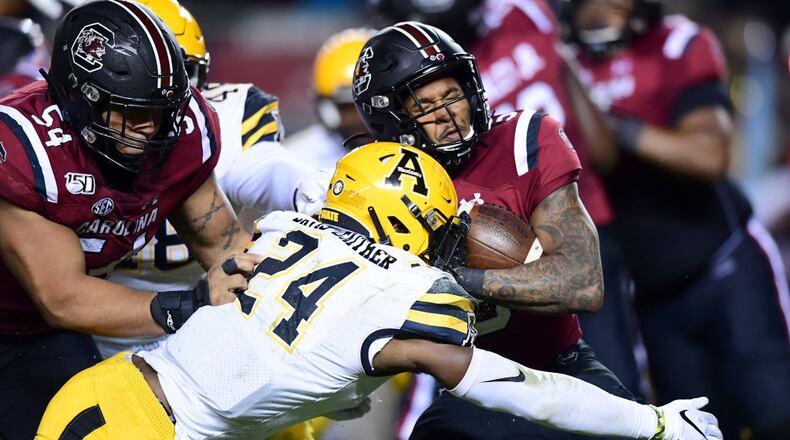 COLUMBIA, SOUTH CAROLINA - NOVEMBER 09: Akeem Davis-Gaither #24 of the Appalachian State Mountaineers tackles Rico Dowdle #5 of the South Carolina Gamecocks during their game at Williams-Brice Stadium on November 09, 2019 in Columbia, South Carolina. (Photo by Jacob Kupferman/Getty Images)