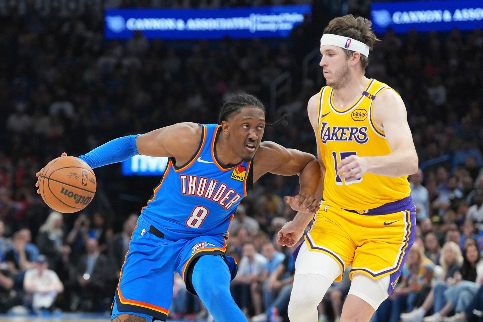Oklahoma City Thunder forward Jalen Williams, left, drives past Los Angeles Lakers guard Austin Reaves, right, during the second half of an NBA basketball game, Tuesday, April 8, 2025, in Oklahoma City. (AP Photo/Kyle Phillips)