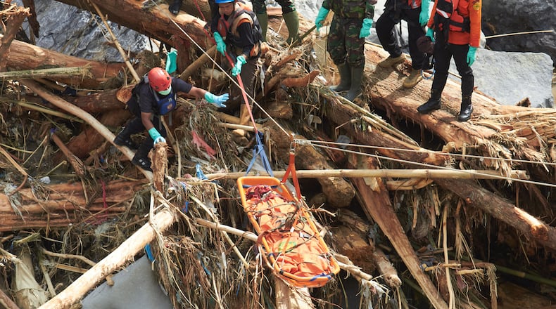 Rescuers use ropes to evacuate the body of a flood victim in Tanah Datar, West Sumatra, Indonesia, Monday, Dec. 1, 2025. (AP Photo/Nazar Chaniago)