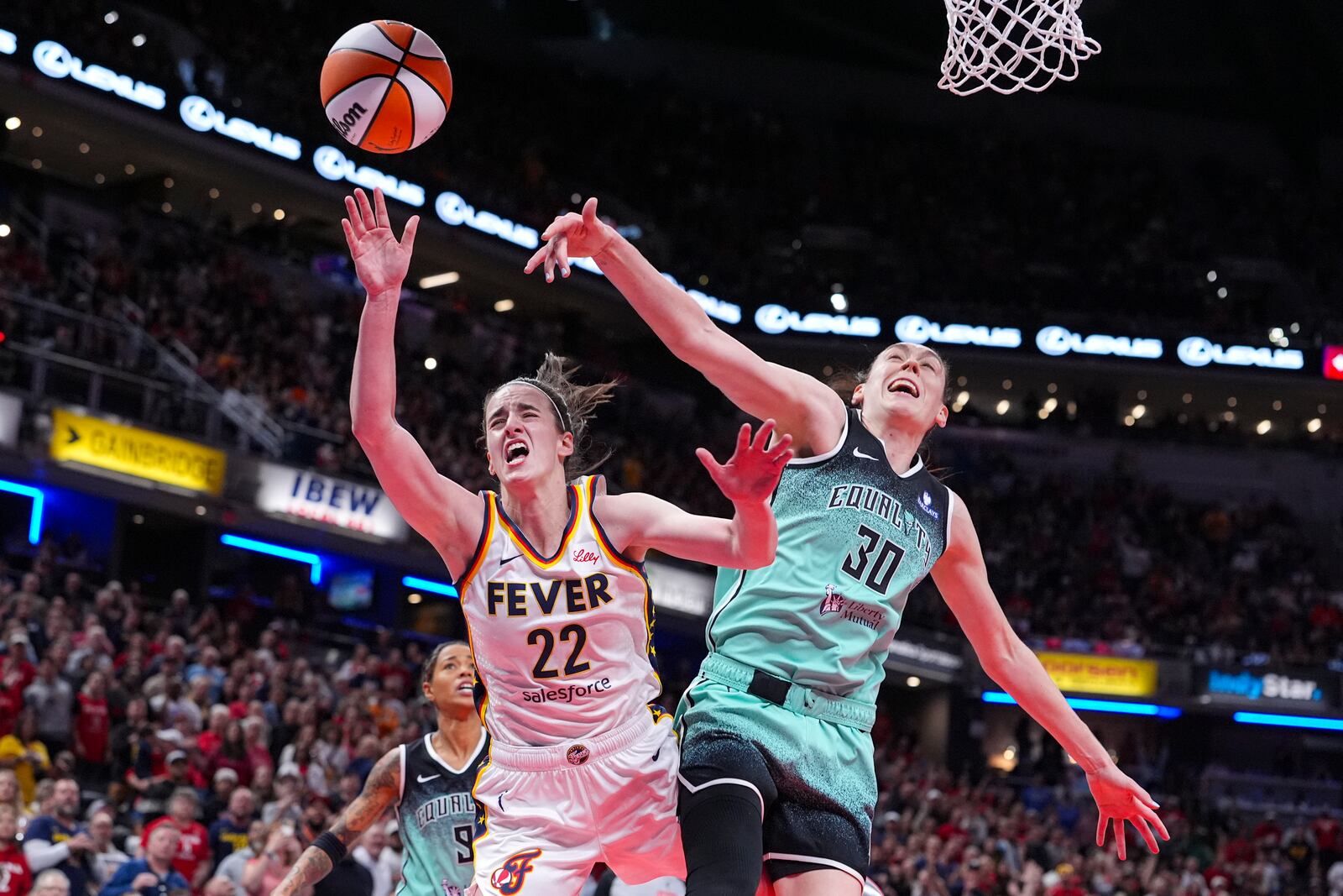 Indiana Fever guard Caitlin Clark (22) reacts after being hit by New York Liberty forward Breanna Stewart (30) in the second half of a WNBA basketball game in Indianapolis, Saturday, May 24, 2025. (AP Photo/Michael Conroy)