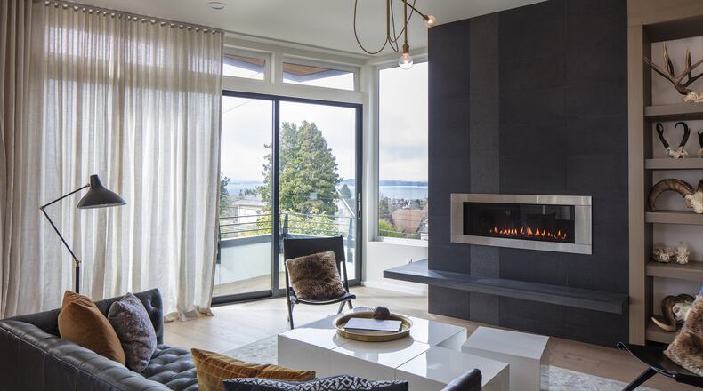 The living room was the first to come together, says interior designer Joy Rondello of J+Studio, who met Magnolia homeowners Katie Finch and Steven Rinella through Homepolish. The modular cubes of the CB2 coffee table double as extra seating; It s especially cool they fit under the fireplace, says Rinella. The modern-industrial brass chandelier by Workstead is kind of fun but not too precious, says Rondello. (Steve Ringman/Seattle Times/TNS)