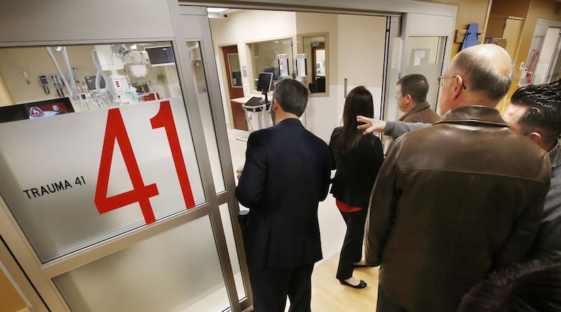 Participants in the opening of a new Emergency Department expansion at Grandview Medical Center tour a new Trauma Room on Tuesday afternoon. The expansion includes 10,400 square feet of remodeled space and 2,600 of new space. TY GREENLEES / STAFF