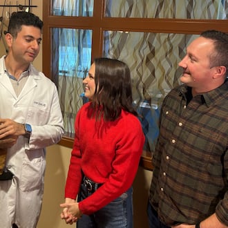 Dr. Amer Sayed holds Archer, 1, as he talks to Archer's parents Casey Gould and Ben Rosenberger during a reunion earlier this month at Atrium Medical Center. It was the first time the four of them had been together since Gould nearly died after child birth. RICK McCRABB/CONTRIBUTOR