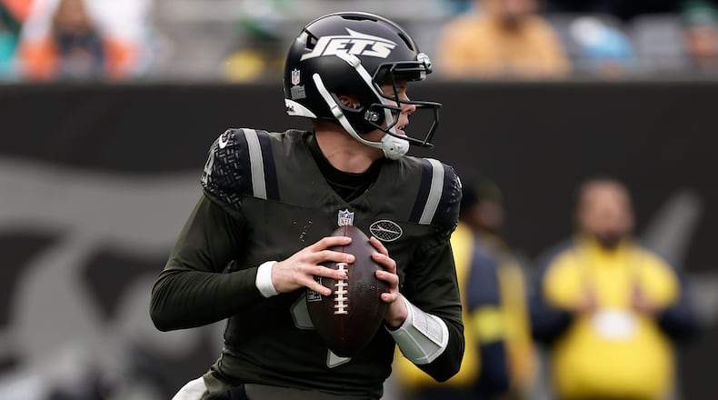 New York Jets quarterback Brady Cook (4) looks to pass against the Miami Dolphins during the second quarter of an NFL football game, Sunday, Dec. 7, 2025, in East Rutherford, N.J. (AP Photo/Adam Hunger)