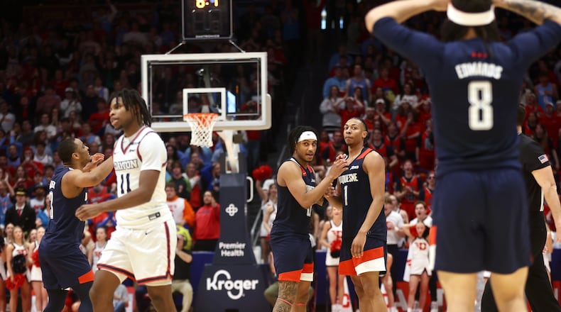 Duquesne players react after Cam Crawford (1) fouled Dayton's Malachi Smith with six seconds to play in a tie game on Saturday, Feb. 15, 2025, at UD Arena.. David Jablonski/Staff