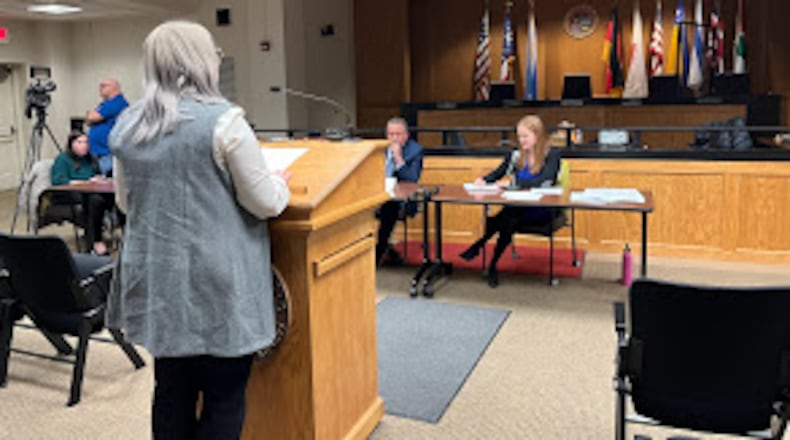 Keelie Gustin, chief policy officer at Miami Valley Community Action Partnership, spoke to a member of and an attorney for the Public Utilities Commission of Ohio Thursday. THOMAS GNAU/STAFF