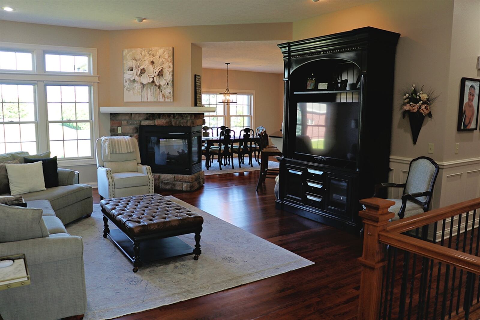 A three-sided stone gas fireplace divides the social spaces yet can be enjoyed from every room.