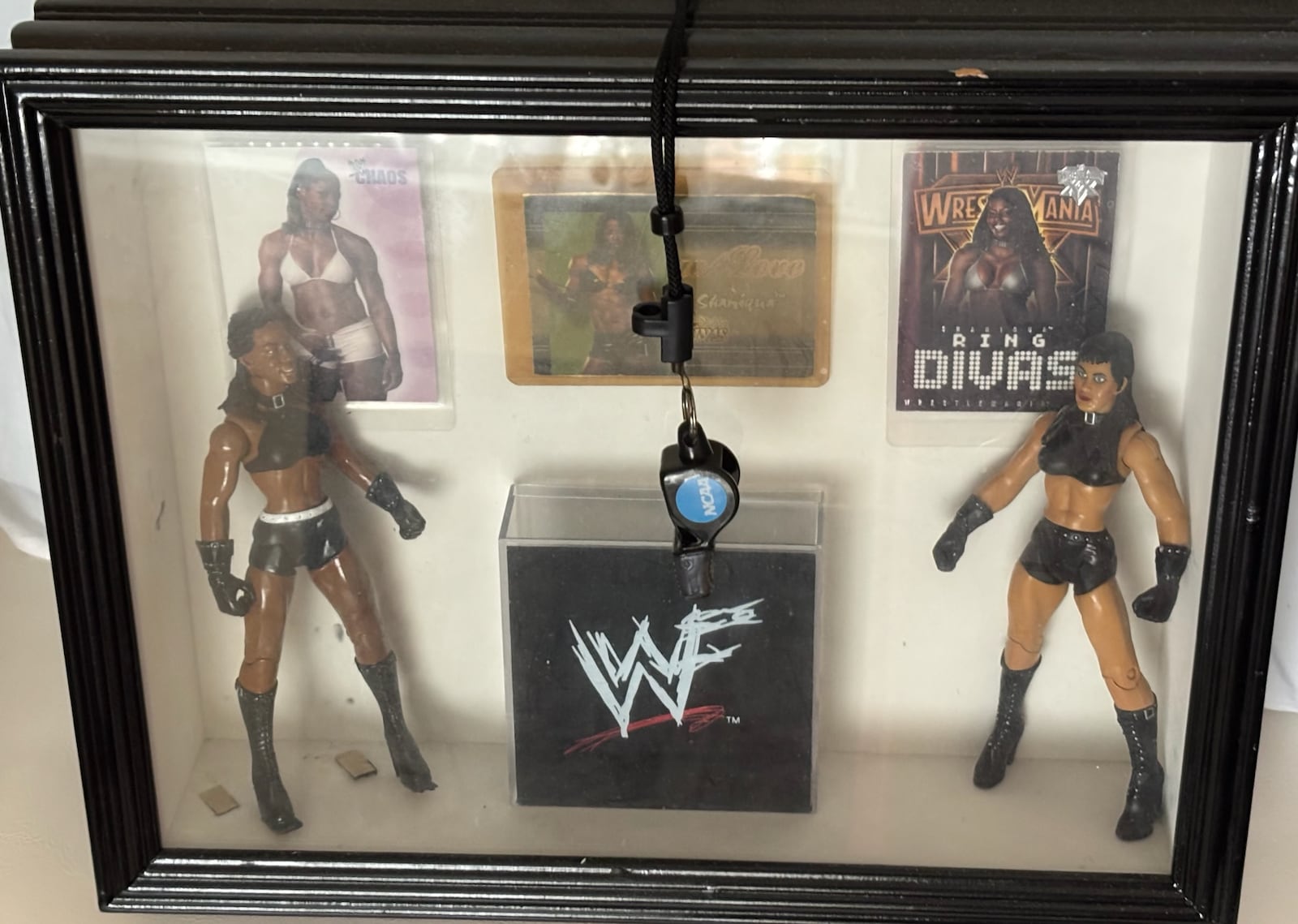 A display at Linda Miles' home in Cincinnati includes several action figures made during her time as Shaniqua in the WWE. CONTRIBUTED PHOTO