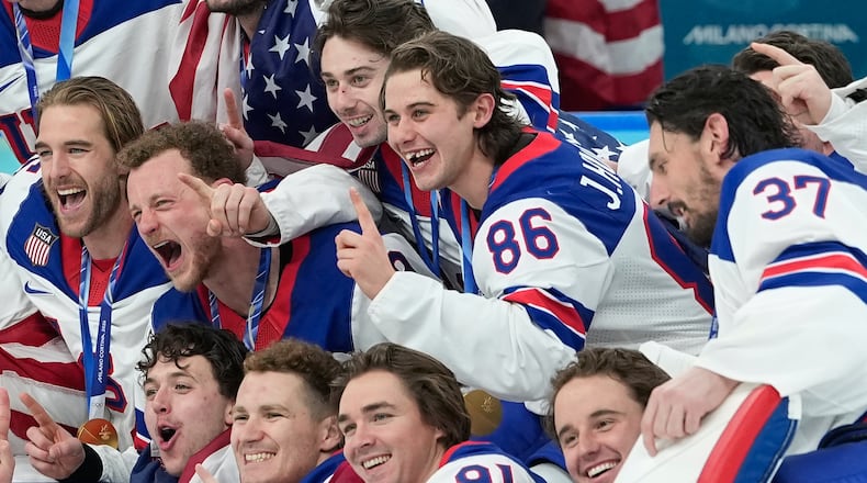 United States' Jack Hughes (86) poses with teammates after a men's ice hockey gold medal game between Canada and the United States at the 2026 Winter Olympics, in Milan, Italy, Sunday, Feb. 22, 2026. (AP Photo/Petr David Josek)