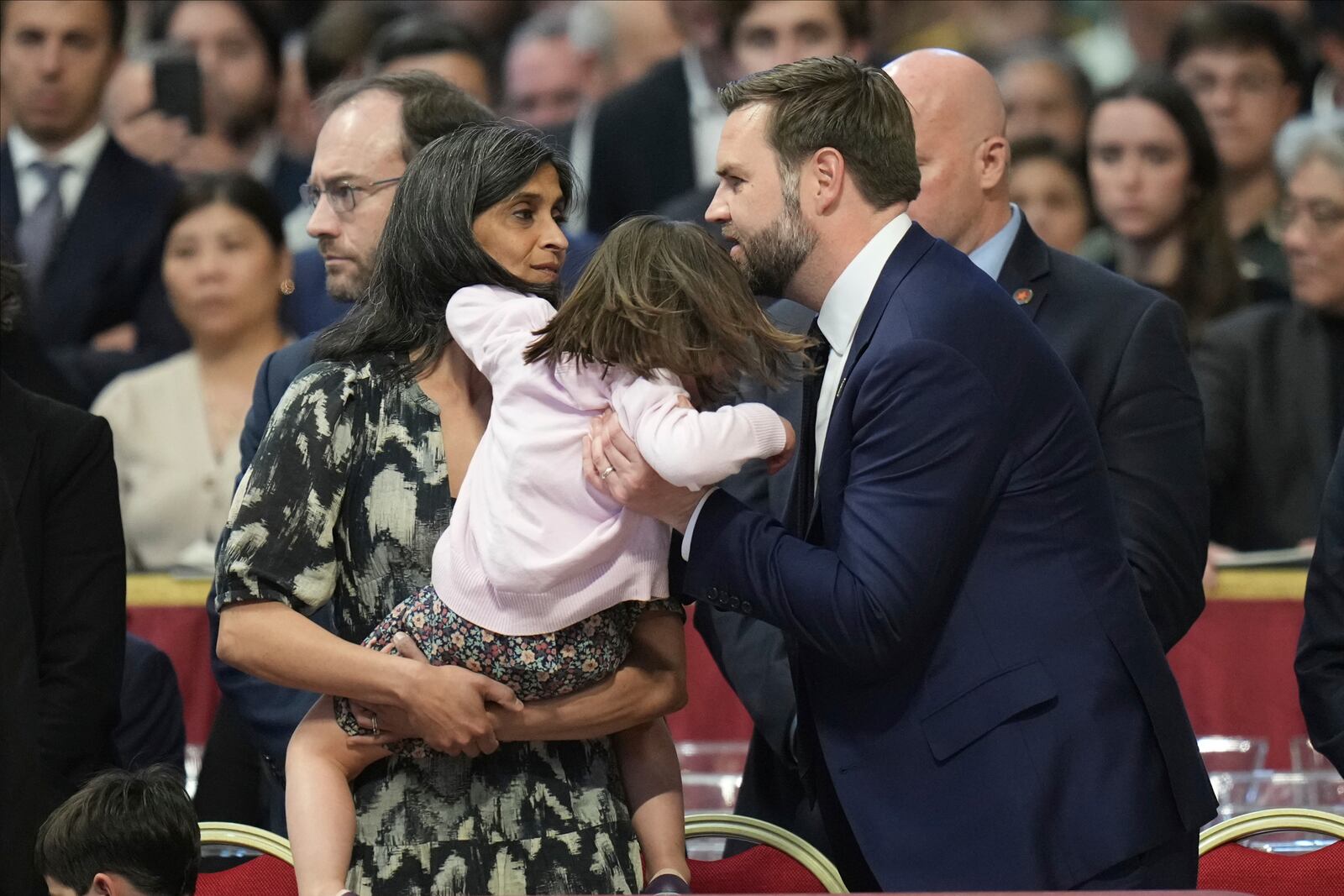 U.S. Vice President JD Vance, his wife Usha Vance, left, arrive with their daughter Mirabel, back to camera for a Good Friday service inside St. Peter's Basilica at the Vatican, Friday, April 18, 2025. (AP Photo/Alessandra Tarantino)