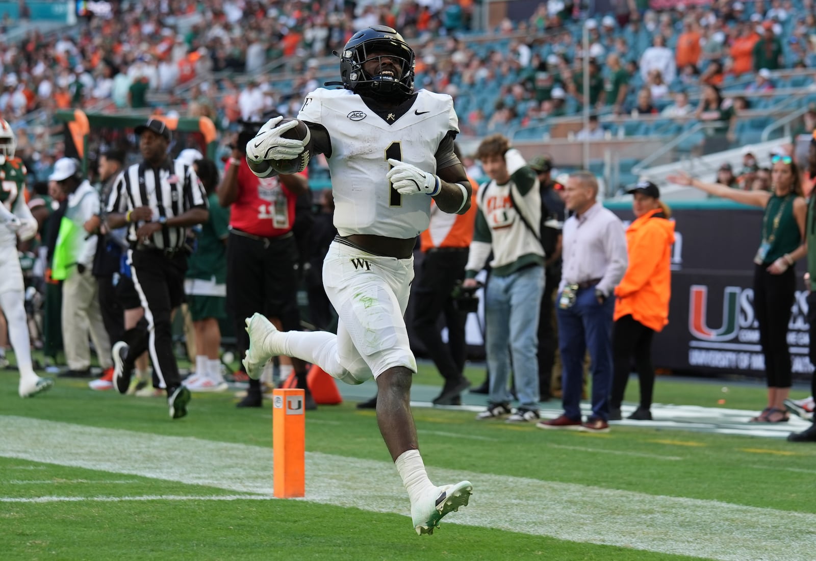 FILE - Wake Forest running back Demond Claiborne (1) runs back a kick return for a touchdown during the first half of an NCAA college football game against Miami, Saturday, Nov. 23, 2024, in Miami Gardens, Fla. (AP Photo/Lynne Sladky, File)