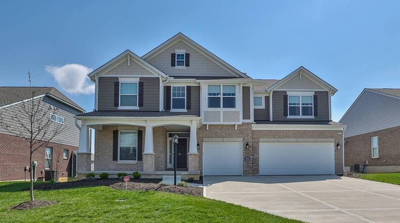 This nearly new two story has a three car attached garage and a covered front porch.