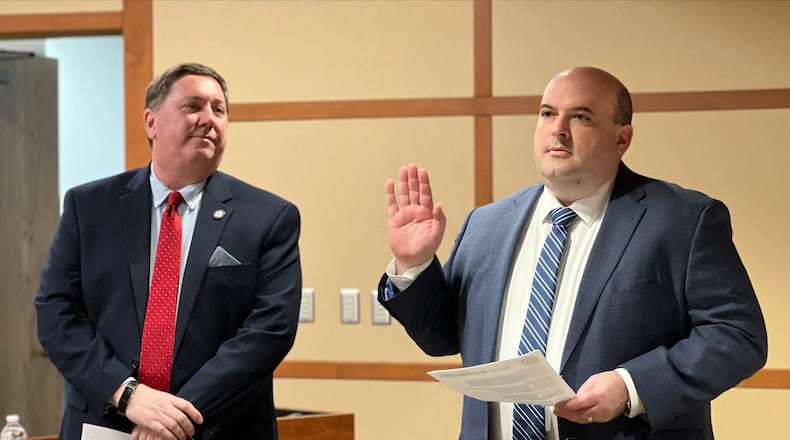 Russ Joseph is sworn in as deputy director of the Montgomery County Board of Elections on Wednesday, March 1, 2023, as elections director Jeff Rezabek looks on. AIMEE HANCOCK/STAFF