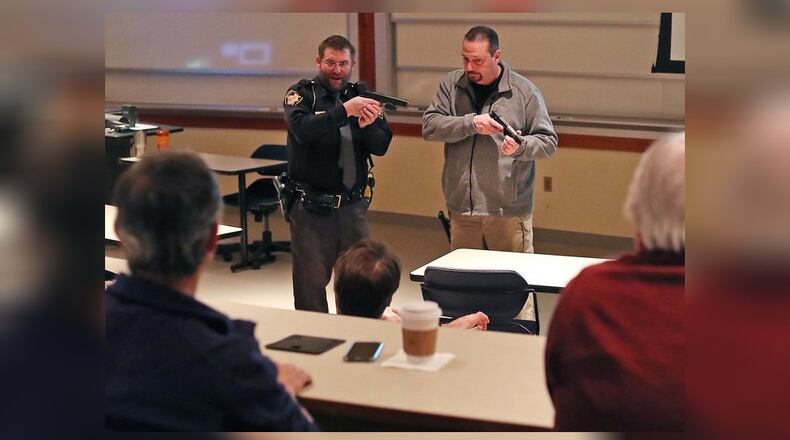 Clark County Sheriff’s deputy Scott Cultice and Dave Lyle, coordinator of safety and security at Springfield City School, demonstrate a situation during an Active Threat Respose Class at Wittenberg University Thursday. Bill Lackey/Staff