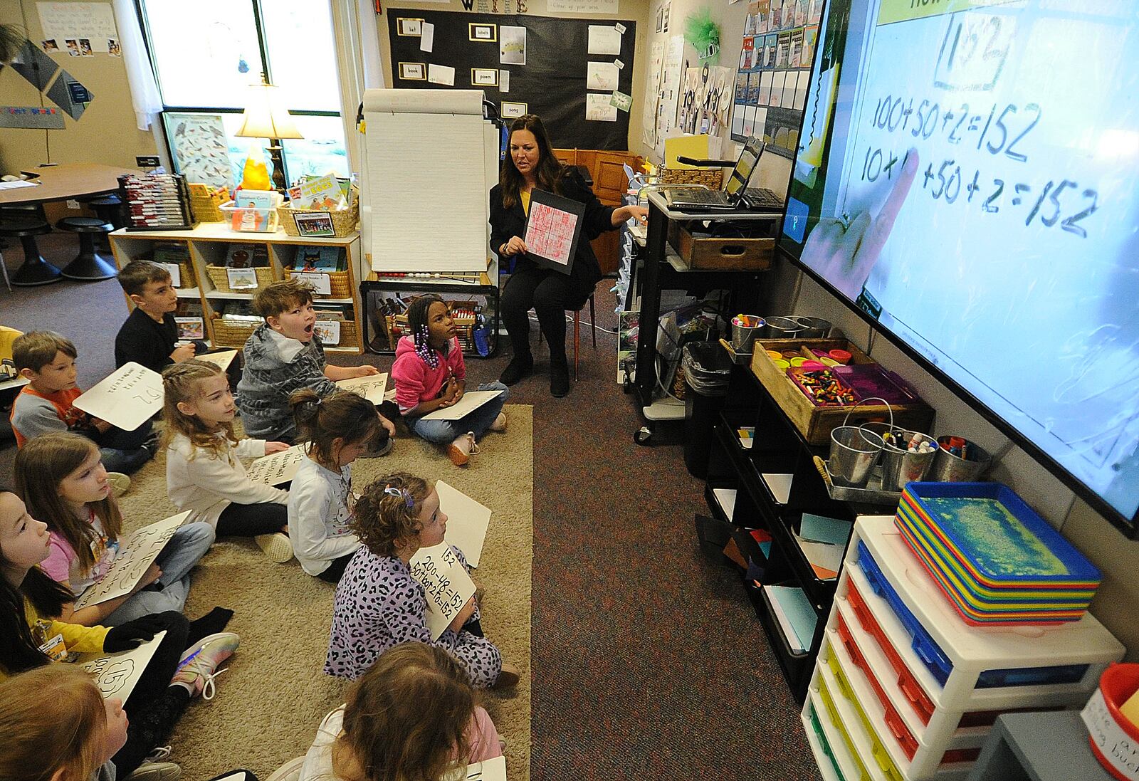 Primary Village North first grade teacher Sarah Jacobs works on math skills Monday, April 22, 2024 with her students. Centerville has seen their math scores rise since the pandemic.  MARSHALL GORBY\STAFF