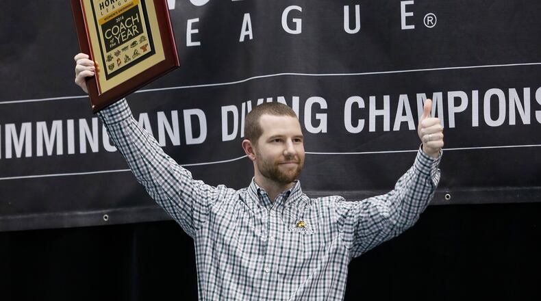 Wright State swimming coach Kyle Oaks celebrates with his 2016 Horizon League Coach of the Year award. SUBMITTED PHOTO