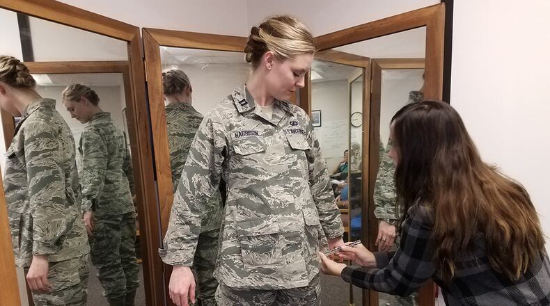 Stacey Butler (right) a clothing designer with the Air Force Life Cycle Management Center’s Air Force Uniform Office, measures Capt. Taylor Harrison’s maternity Airman Battle Uniform. The new uniforms were designed and developed by the office and are available to pregnant Airmen around the world. (U.S. Air Force photo/Brian Brackens)