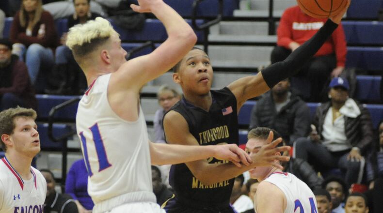 Mekhi Elmore (with ball) of Thurgood avoids Thomas Myers of Massie. Thurgood Marshall defeated Clinton-Massie 68-51 in a D-II boys high school basketball sectional semifinal at Trent Arena on Tuesday, Feb. 26, 2019. MARC PENDLETON / STAFF