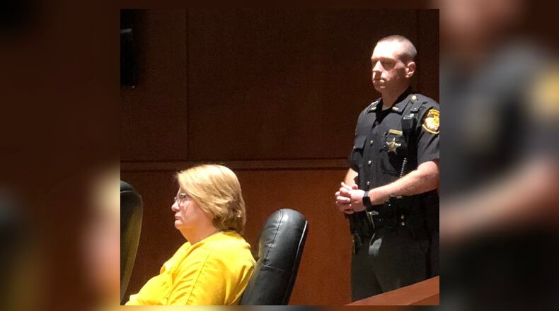 Renee K. Nichols, 65, of Springboro, listens during a bond reduction hearing in Warren County Common Pleas Court. STAFF/LAWRENCE BUDD