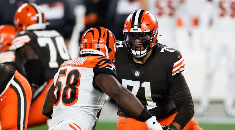 Cleveland Browns offensive tackle Jedrick Wills (71) plays against Cincinnati Bengals defensive end Carl Lawson (58) during the first half of an NFL football game, Thursday, Sept. 17, 2020, in Cleveland. (AP Photo/Ron Schwane)