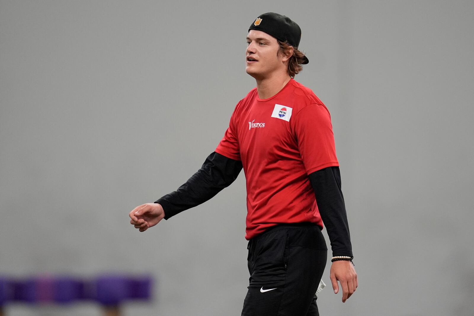 Minnesota Vikings quarterback J.J. McCarthy (9) walks across the field during an NFL football team practice in Eagan, Minn., Tuesday, April 29, 2025. (AP Photo/Abbie Parr)