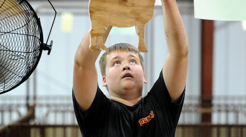 Connor Bogan, age 12, of Jamestown, prepares a pen for his goat Friday, July 28, 2023 at the Greene County Fairgrounds. MARSHALL GORBY\STAFF