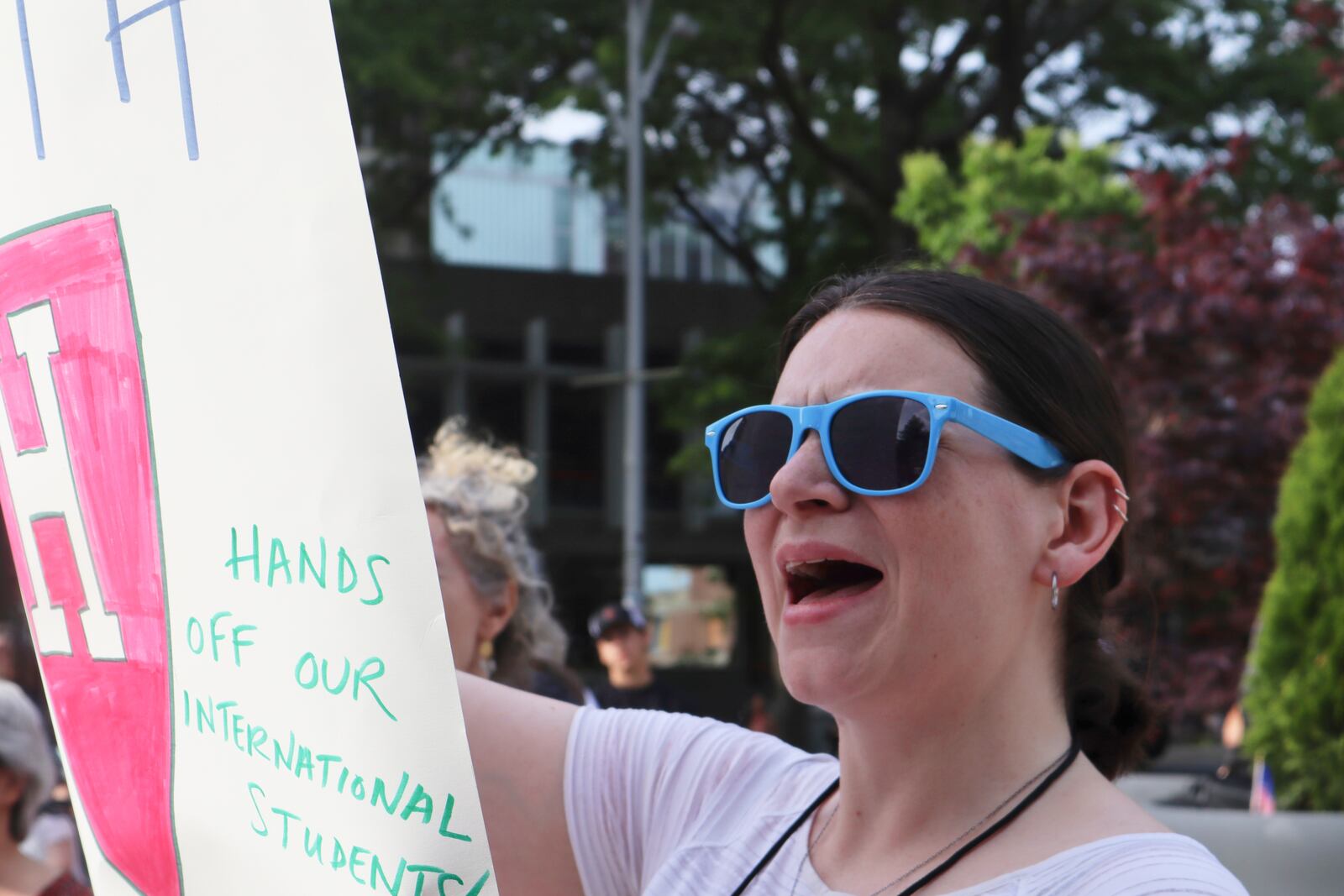 A protester cheers while listening to Harvard University students speak at a protest against President Donald Trump's recent sanctions against Harvard in front of Science Center Plaza on Tuesday, May 27, 2025, in Cambridge, Mass. (AP Photo/Leah Willingham)