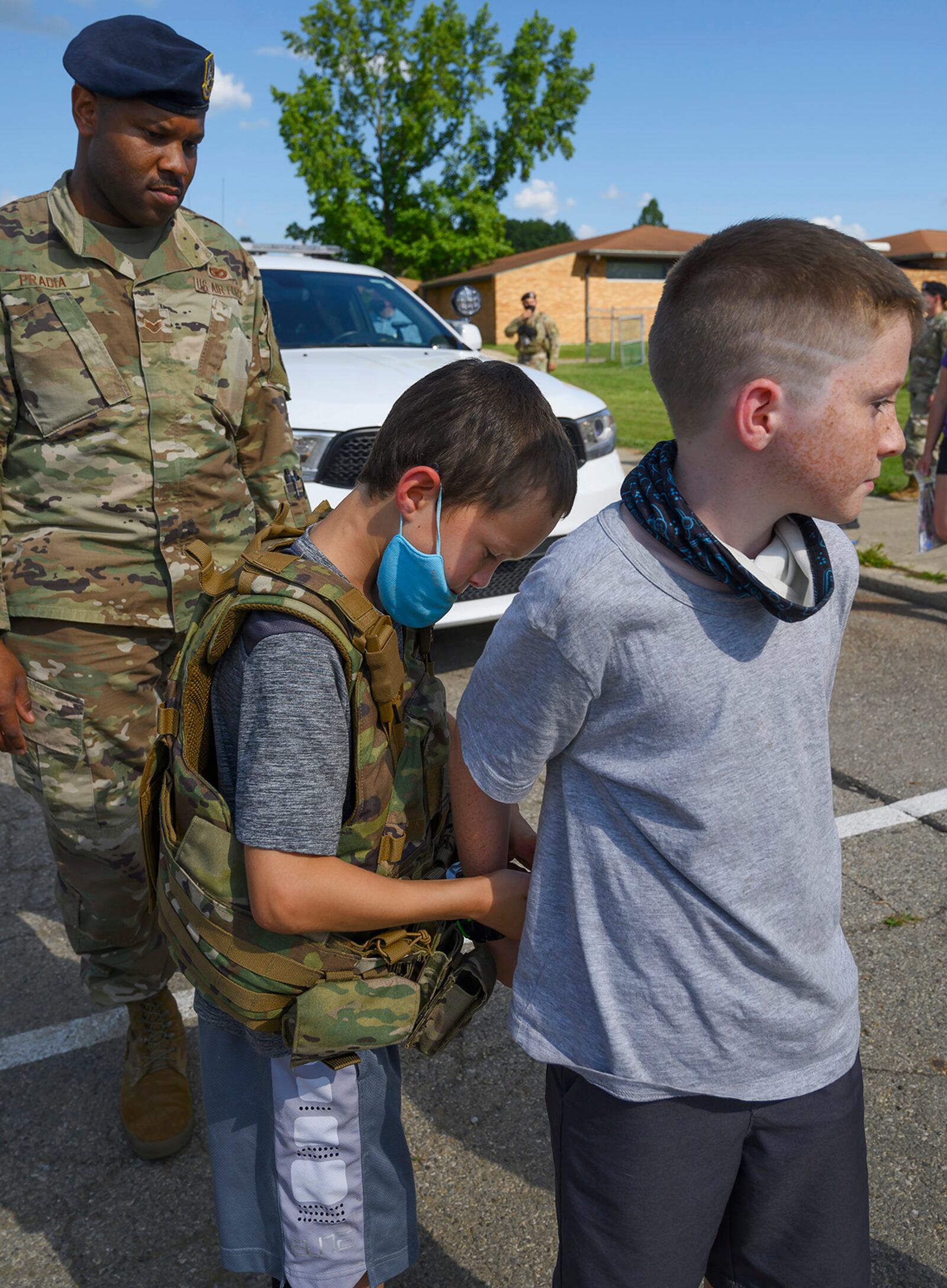 Senior Airman Anthony Pradia, 88th Security Forces Squadron, watches as Marcus Roley, 9, handcuffs Jacen Hogge, 10, in a mock “arrest” during National Night Out on Aug. 3 at Wright-Patterson Air Force Base. The 88 SFS outreach event offered the community a chance to get to know the “Defenders.” U.S. AIR FORCE PHOTO/R.J. ORIEZ