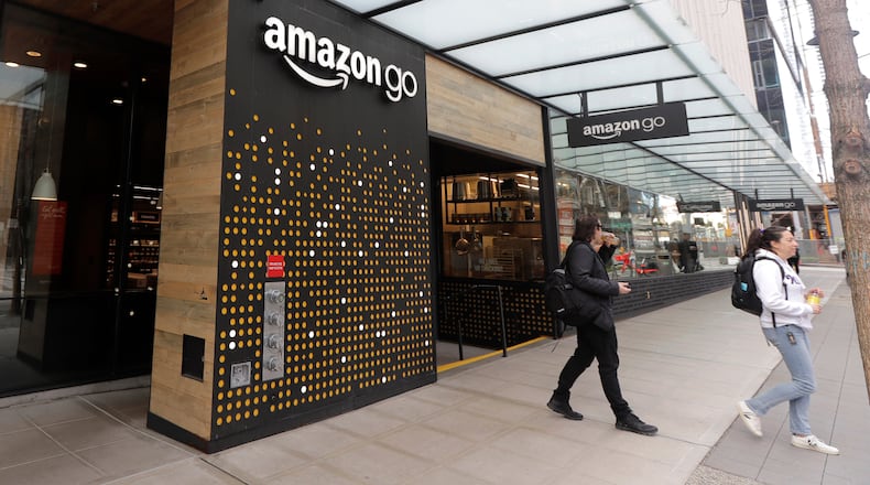 FILE - People walk out of an Amazon Go store in Seattle, March 4, 2020. (AP Photo/Ted S. Warren, File)