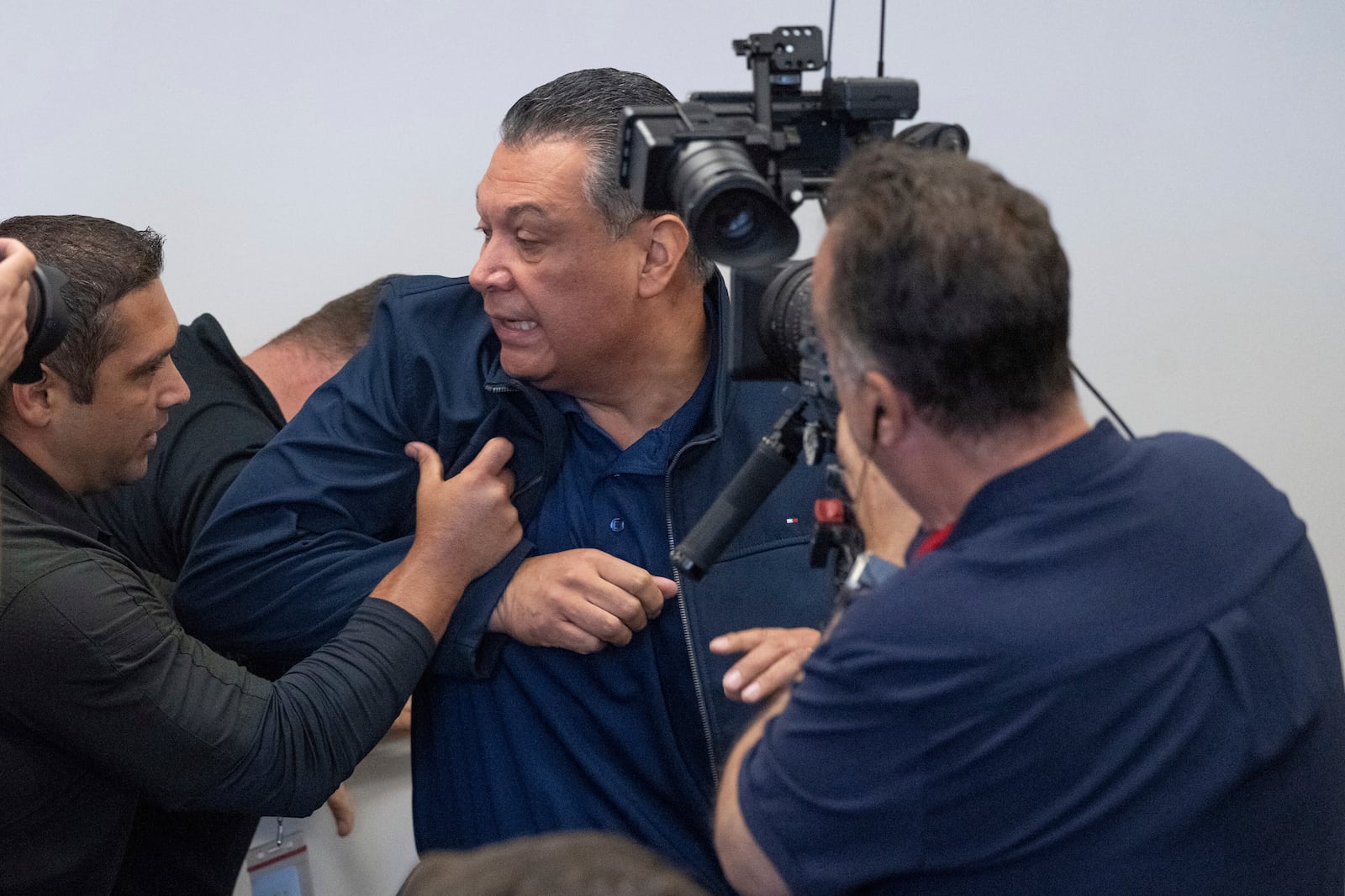 U.S. Sen. Alex Padilla, D-Calif., is pushed out of the room as Homeland Security Secretary Kristi Noem holds a news conference regarding the recent protests in Los Angeles, Thursday, June 12, 2025. (David Crane/The Orange County Register via AP)