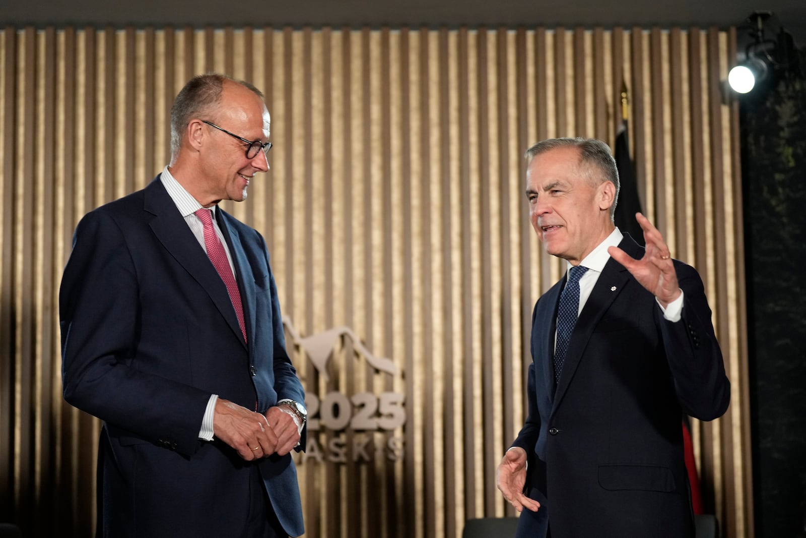 Canadian Prime Minister Mark Carney, right, meets with German Chancellor Friedrich Merz ahead of the G7 Summit at the Pomeroy Kananaskis Mountain Lodge, about 62 miles (100 kilometers) west of Calgary, in Kananaskis, Alberta, Sunday, June 15, 2025. (Adrian Wyld/The Canadian Press via AP)