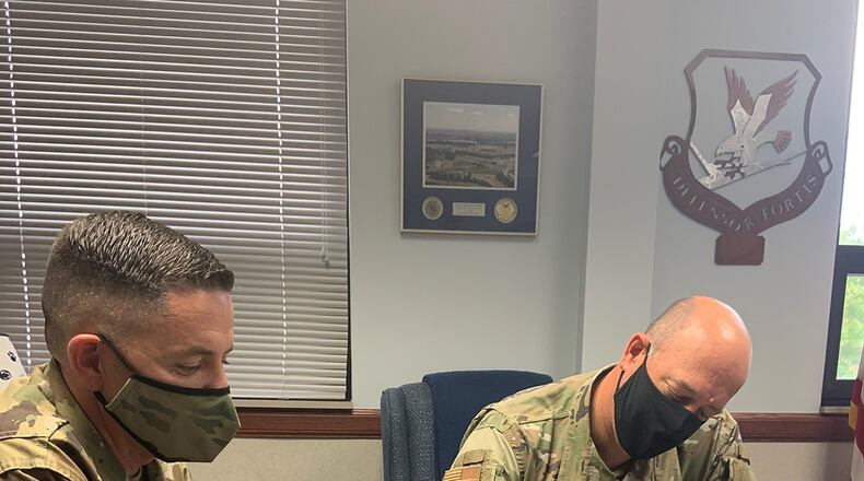 Chief Master Sgt. Jason Shaffer (left), 88th Air Base Wing command chief, looks on while Col. Patrick Miller, 88th Air Base Wing and installation commander, signs a proclamation for Women’s Equality Day on Aug. 26. This year’s theme for Women’s Equality Day is ‘Beyond the Scope of Women’s Suffrage: 100 Years of Progress,’ marking the 100th anniversary of the signing of the 19th Amendment affording women the right to vote. (U.S. Air Force photo/Stacey Geiger)