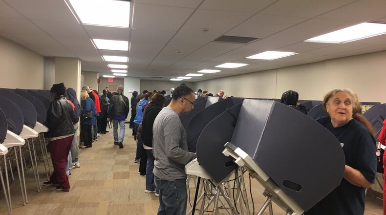 Early voters cast their ballots on electronic voting machines at the Montgomery County Board of Elections in 2016. Ohio counties are looking to replace voting machines, and those who now use touchscreen equipment could switch to optical scan paper ballots. LYNN HULSEY/STAFF