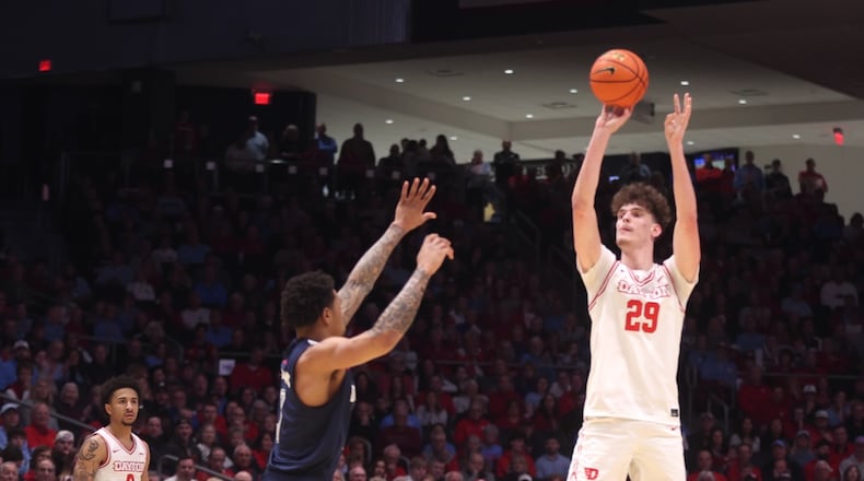 Dayton's Amaël L'Etang makes a 3-pointer in the first half against Duquesne on Saturday, Feb. 21, 2026, at UD Arena. David Jablonski/Staff