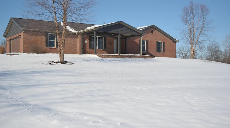 The brick ranch sits on three plus acres and has two out buildings and a two car side entry garage