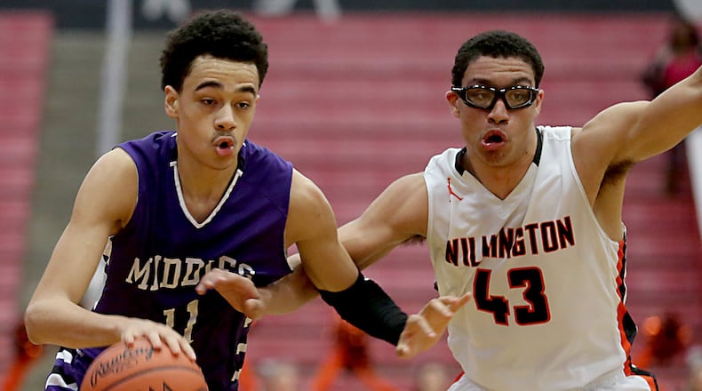 Middletown guard Cliff Snow is covered by Wilmington guard Jeffery Mansfield during their Division I sectional semifinal Tuesday night at Fairfield Arena. CONTRIBUTED PHOTO BY E.L. HUBBARD