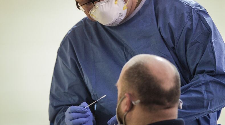 Sgt. Nicholas Robinson with the Ohio National Guard, administers a COVID-19 test at Bethesda Temple on Salem Wednesday Dec. 9, 2020. Montgomery County Public Health organized the pop-up test.