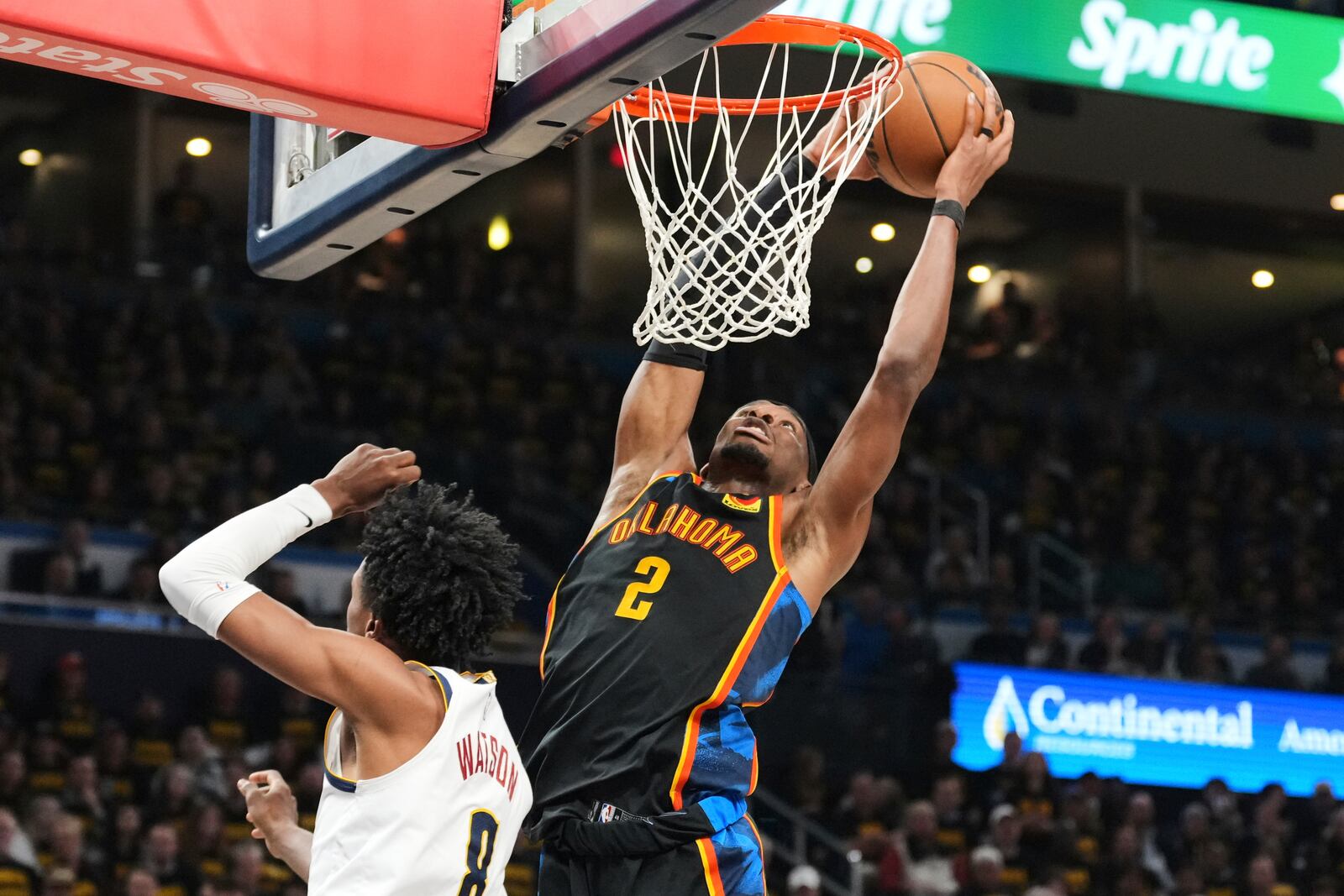 Oklahoma City Thunder guard Shai Gilgeous-Alexander (2) leaps to the basket for a shot over Denver Nuggets' Peyton Watson (8) in the second half of Game 2 in the conference semifinals of the NBA basketball playoffs, Wednesday, May 7, 2025, in Oklahoma City. (AP Photo/Kyle Phillips)