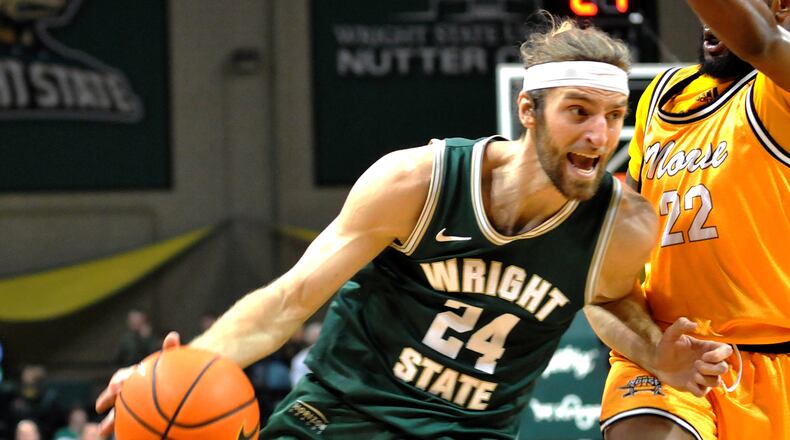 Wright State's Tim Finke, 24, drives past Northern Kentucky's Trevon Faulkner, 22, during the first half of a Horizon League game at the Nutter Center on Friday, Feb. 10. DAVID A. MOODIE/CONTRIBUTING PHOTOGRAPHER